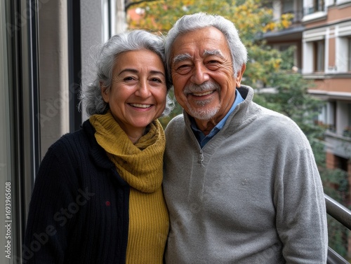 Happy Hispanic couple enjoying autumn on urban balcony