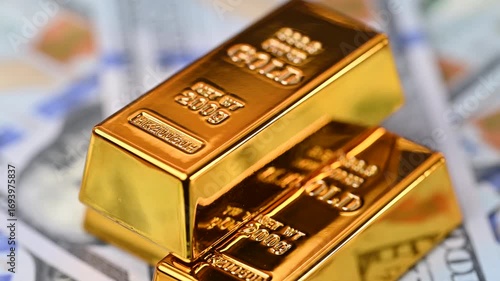 gold bars with dollar bills