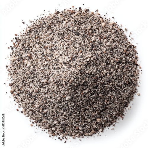 Pile of ground, dark gray, earthy material with white particles scattered throughout on white background