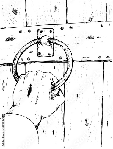 Hand grasping ancient ring knocker on weathered wooden door, inviting entry or seeking audience.