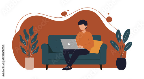 Young man working remotely on his laptop from the comfort of his modern living room couch. Ideal for concepts of home office, online learning, or digital lifestyle.