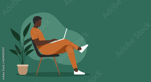 Young Black man casually works on his laptop from home, embodying remote work and a modern digital lifestyle. Ideal for business, education, or freelance concepts.
