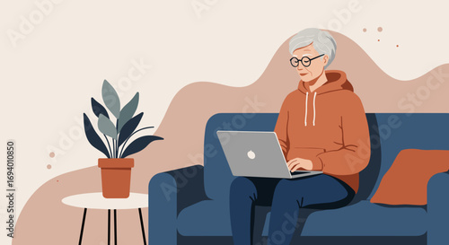 Senior woman comfortably using a laptop on a sofa at home, representing digital connection, online learning, and a modern relaxed lifestyle for older adults.
