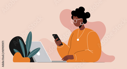 A focused Black woman uses her smartphone and laptop, illustrating modern remote work, digital communication, and online productivity in a contemporary home office setting.