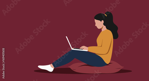 A woman sitting comfortably on a pillow, working or studying on her laptop. Ideal for concepts of remote work, online learning, or casual lifestyle.