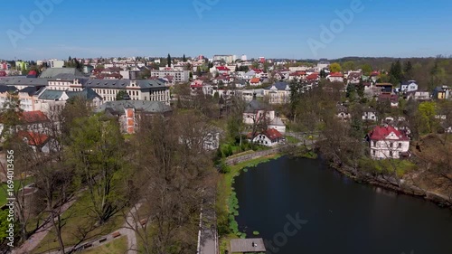 Scenic aerial wide shot of Park Budoucnost, featuring green space, a pond, and the historic townscape of Havlickuv Brod, Vysocina, Czech Republic.