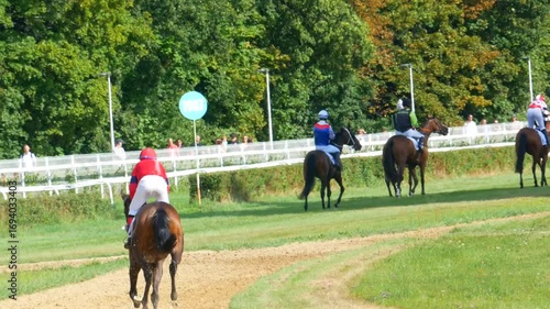 Wroclaw, Poland - September 7, 2025 Video of jockeys riding horses after finishing a race at the racetrack in Wroclaw, Poland. Horses slowing down on the track after competition.
