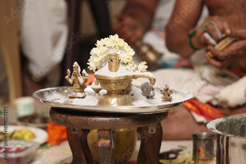 Performing Pooja for Hindu god siva linga with milk, honey and coconut water	
