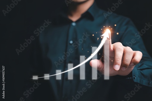 An individual's hand interacting with a virtual upward-trending chart, symbolizing business growth and success. This image suggests progress, achievement, and strategic planning