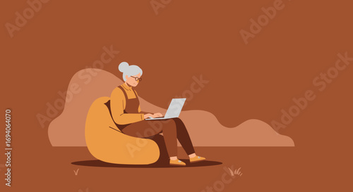 Smiling senior woman comfortably using a laptop on a bean bag chair. Depicts digital literacy, remote work, or modern elder leisure. Ideal for technology and lifestyle.