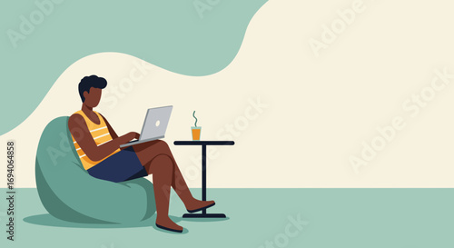 Young man comfortably works remotely on his laptop from home. Captures modern telecommuting, online learning, or freelance business concepts with a relaxed lifestyle.