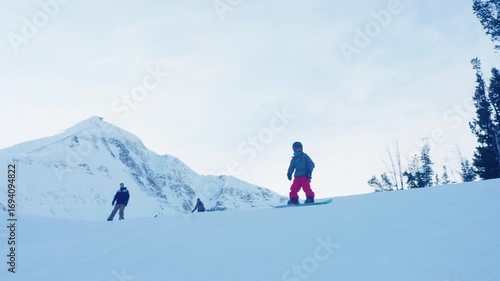People snowboaring in mountains at winter