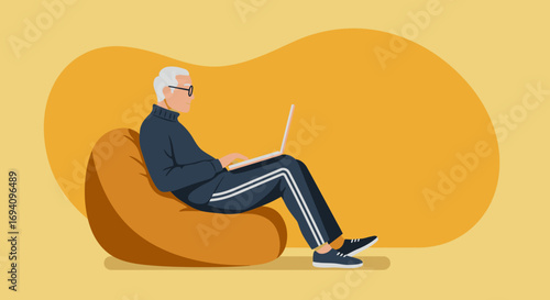 Elderly man comfortably using a laptop on a bean bag chair at home. Represents modern retirement, remote work, or leisure with technology.