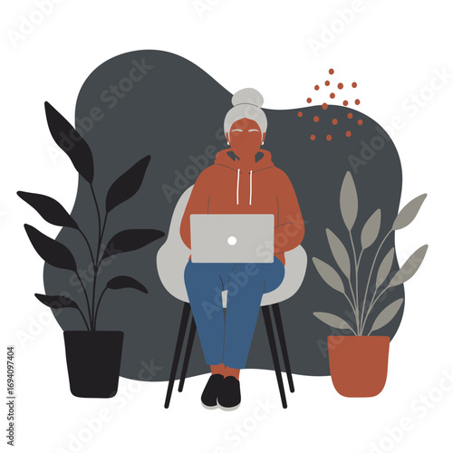 Modern senior woman working remotely on laptop at home. Illustrates digital literacy, flexible work, and an active lifestyle for older adults.