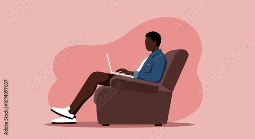Young man working remotely on a laptop in a comfortable armchair at home. Represents freelance, online learning, or digital lifestyle.