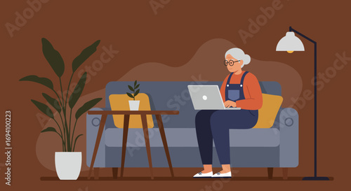 Senior woman working or browsing on a laptop from the comfort of her sofa at home. Concept of digital literacy, remote work, or leisure.
