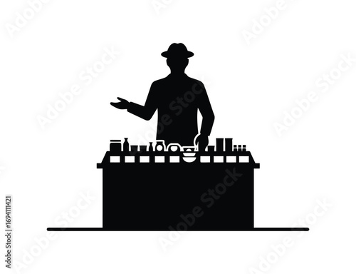 Silhouette of a vendor selling goods at a stall