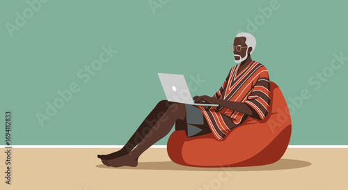 Elderly African man comfortably working on a laptop from a bean bag chair at home, embodying modern remote work and digital lifestyle.