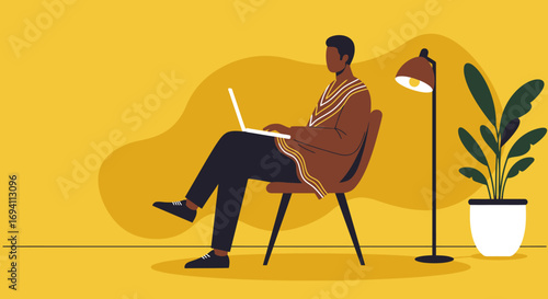 African American man working remotely on a laptop in a relaxed home office setting. Represents remote work, modern lifestyle, and productivity.