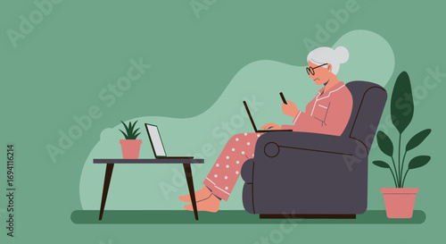 Senior woman comfortably uses laptop and smartphone at home, connecting with technology in her pajamas. Ideal for lifestyle, retirement, or digital communication concepts.