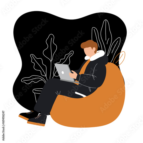 Young man focused on his laptop while sitting comfortably on a bean bag chair, representing remote work, online learning, or digital lifestyle.