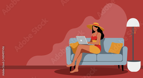 Focused woman in a swimsuit and sun hat working on a laptop from a comfortable sofa, representing flexible remote work and summer leisure.