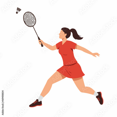 Dynamic female athlete in action hitting shuttlecock with badminton racket