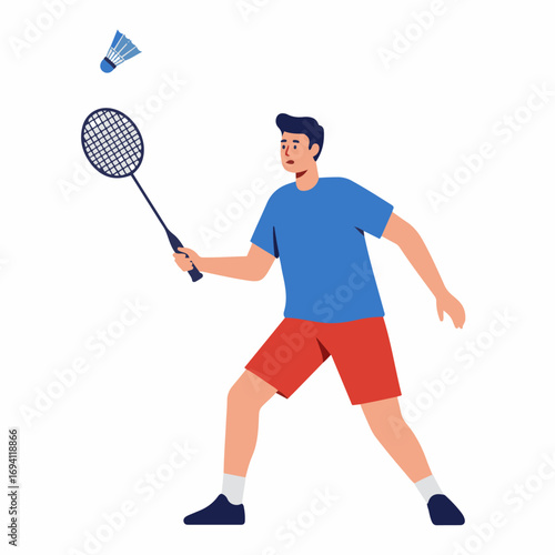 Energetic young man playing badminton with racket and shuttlecock