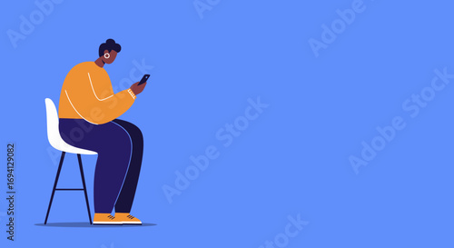 Person focused on a smartphone while sitting on a stool against a blue background, depicting digital communication, connectivity, and modern lifestyle.