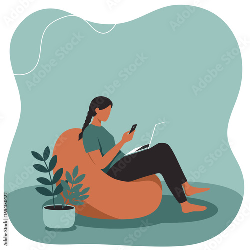 Woman working remotely on laptop and phone from a comfortable bean bag at home, balancing productivity with modern digital lifestyle and communication.