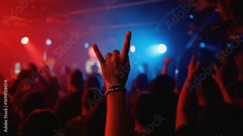 Making the horns gesture at a concert.