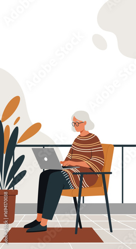 A senior woman comfortably works on her laptop on a modern balcony, embracing remote work and a digital lifestyle. Ideal for technology, business, or home life concepts.