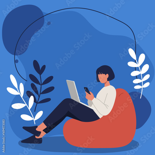 Young person on a bean bag, multitasking with a laptop and smartphone in a modern, casual setting. Remote work or digital communication.