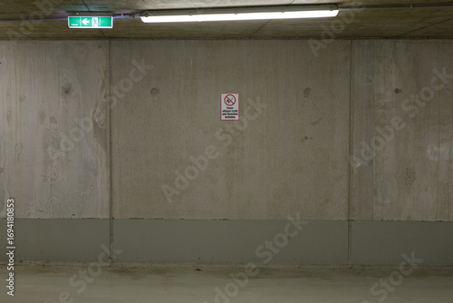Fotografie Stock photo of a plain concrete wall in a parking garage