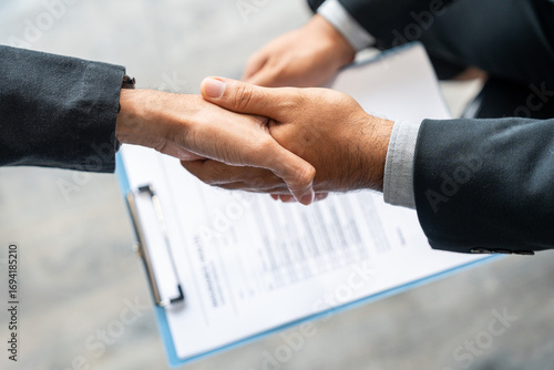 A young couple discusses life health and home insurance plans with an advisor ready to sign documents for future security and peace of mind. Meets with an insurance agent to review and sign policies