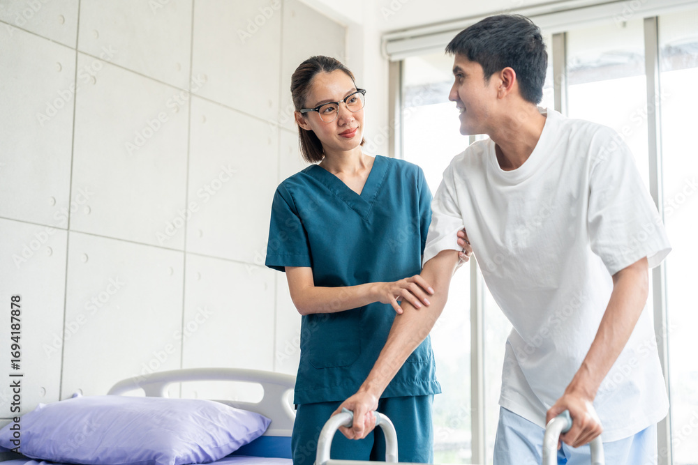Fototapeta premium Physical therapy. Female Nurse aids young man in recovering from spine injury and providing orthopedic massage Orthopedic healthcare and chiropractor with person for physical therapy rehabilitation
