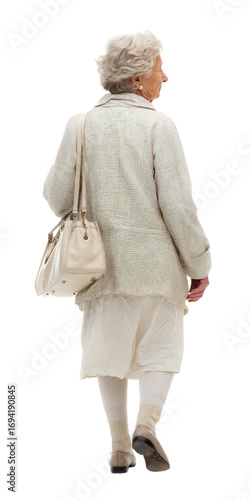 Senior woman walking away carrying a white handbag with elegant outfit