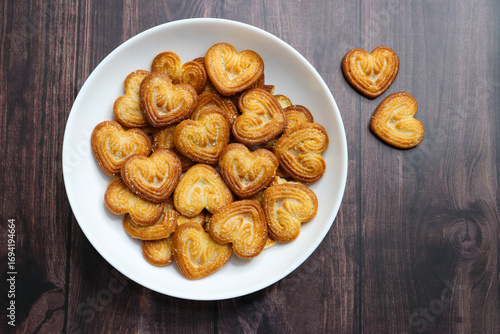 Golden, heart shaped crispy biscuits with a light, flaky texture, coated with sparkling sugar crystals. Ideal for snack concepts, food photography, or sweet treat presentations. Little hearts.