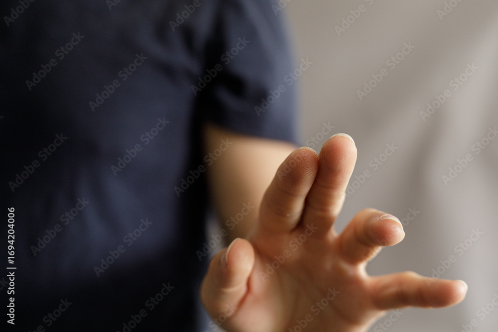 Obraz premium Close-up of a hand making a stop gesture. Perfect for concepts like rejection, denial, or boundaries. High-quality image for websites and presentations.