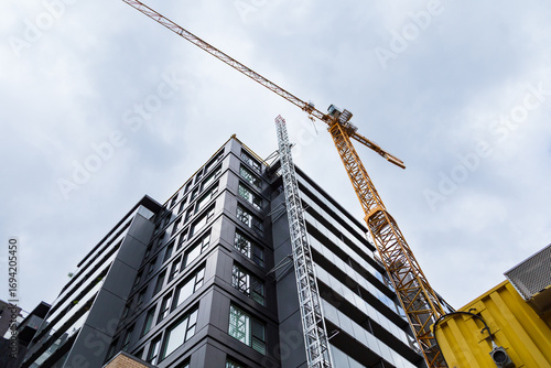 Low angle view of tall building under construction to increase its height to 20 stories on Grande-Allée street in downtown Quebec City, Québec, Canada