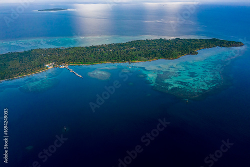 Aerial View of Tropical Island in Clear Blue Ocean