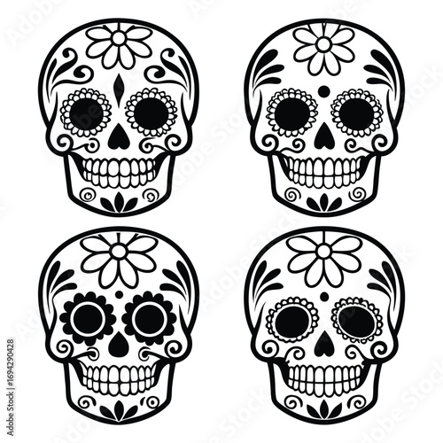Four decorative sugar skulls with floral patterns for day of the dead celebration
