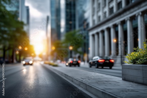 Urban street scene at sunset, featuring blurred cars and vibrant greenery along the sidewalk, showcasing the dynamic atmosphere of city life and modern architecture