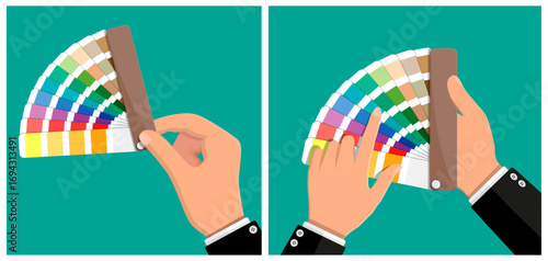 Man hand holding color palette fan and choosing a color. Designer picking color swatch from chart. Paint samples guide for creative project.