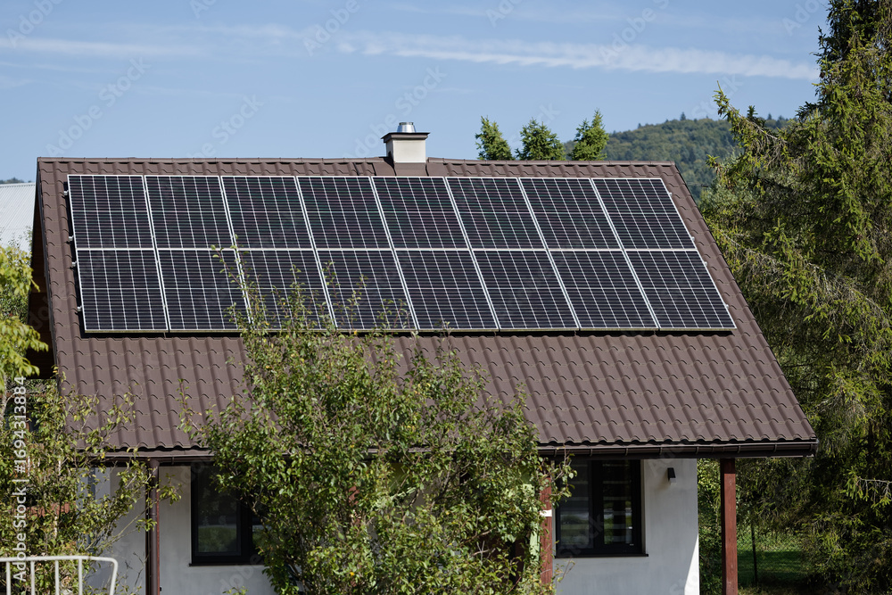 Fototapeta premium Tiny house at countryside with solar panels photovoltaic on the roof. Poland, Europe.
