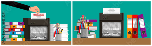 Man's hand shredding confidential document. Paper shredder machine at desk with office supplies. Data privacy and security concept for business.