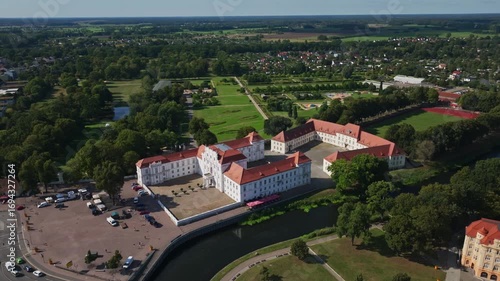 Aerial drone view of Oranienburg Palace (Schlossmuseum Oranienburg), historic baroque landmark and museum surrounded by gardens in Oranienburg, Brandenburg, Germany. 15 September 2024