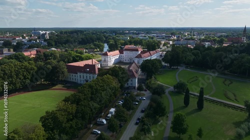 Aerial drone view of Oranienburg Palace (Schlossmuseum Oranienburg), historic baroque landmark and museum surrounded by gardens in Oranienburg, Brandenburg, Germany. 15 September 2024