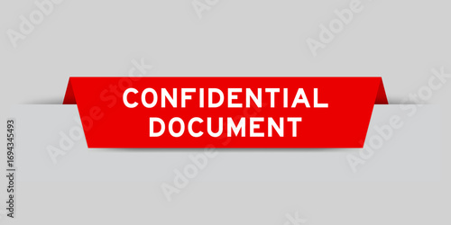 Red color inserted label with word confidential document on gray background