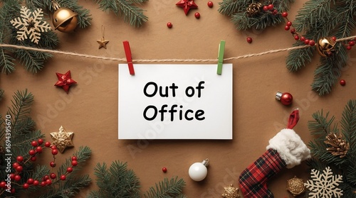 Creative Christmas flat lay with festive decorations, fir branches, stocking, snowflakes, golden ornaments and paper sign with Out of Office text hanging on string for holiday season break concept